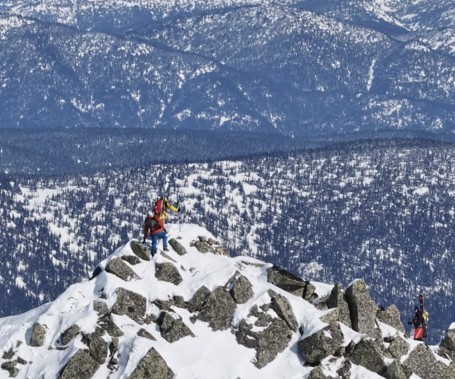 Man on top of a snowcapped mountain